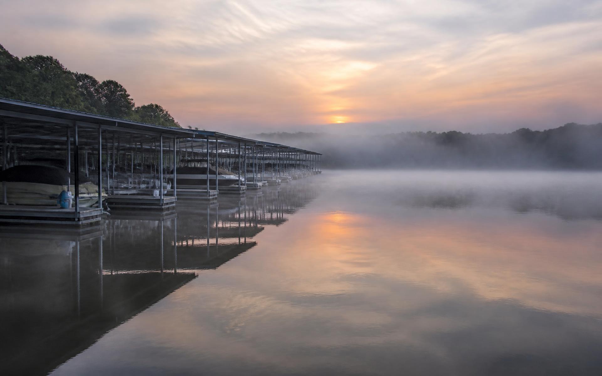 Covered marina slips in morning mist on Lake Norman